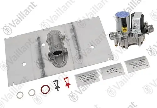 Vaillant Umstellsatz mit einem Metallblech, einem Ventil und verschiedenen Dichtungen, geeignet für Heizungsanwendungen. Teile auf einem neutralen Hintergrund angeordnet.
